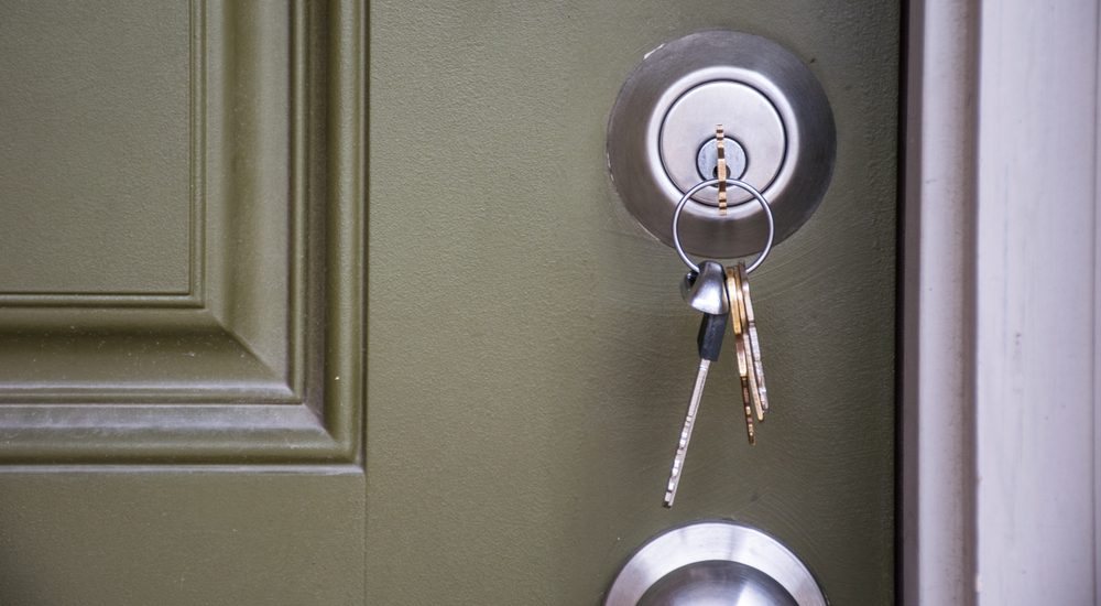 Home Ownership the day you get your new Keys to your new home. House keys inside door lock
