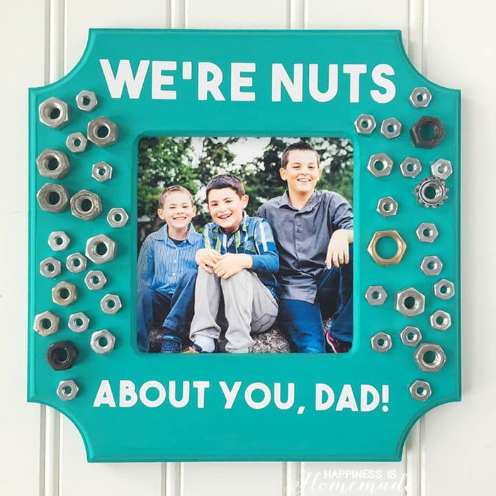 Photo of three boys smiling, framed with metal nuts on a teal frame. Text reads, 