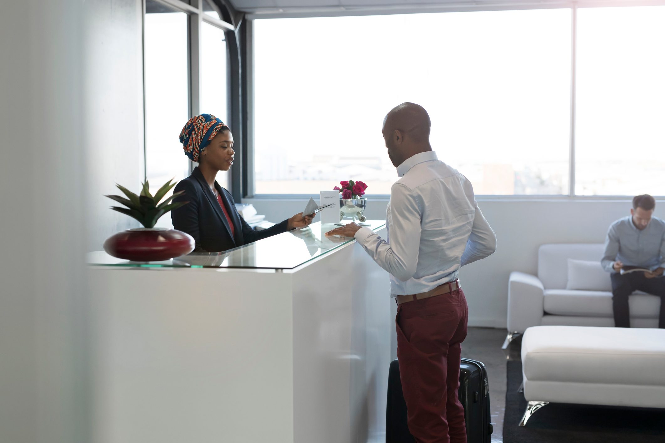 Businesspeople checking in to hotel in the lobby