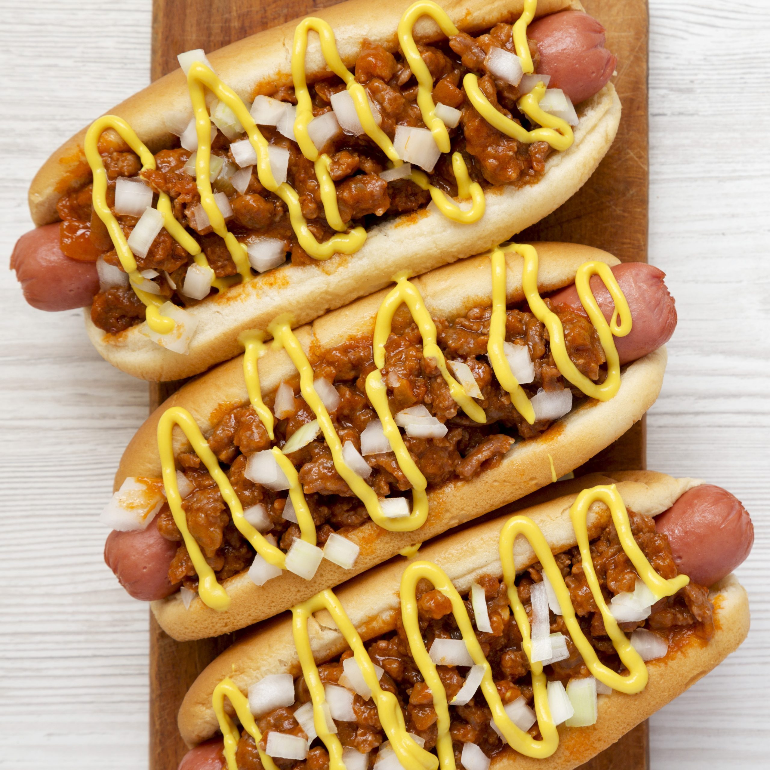 hot weiner with meat sauce, mustard and onions
