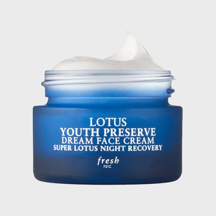 A blue jar containing cream, labeled 