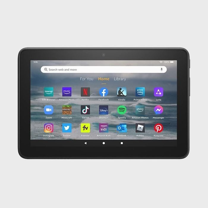 Tablet displaying app icons on the home screen, including Facebook, Netflix, TikTok, and Spotify, set against an ocean wave background.