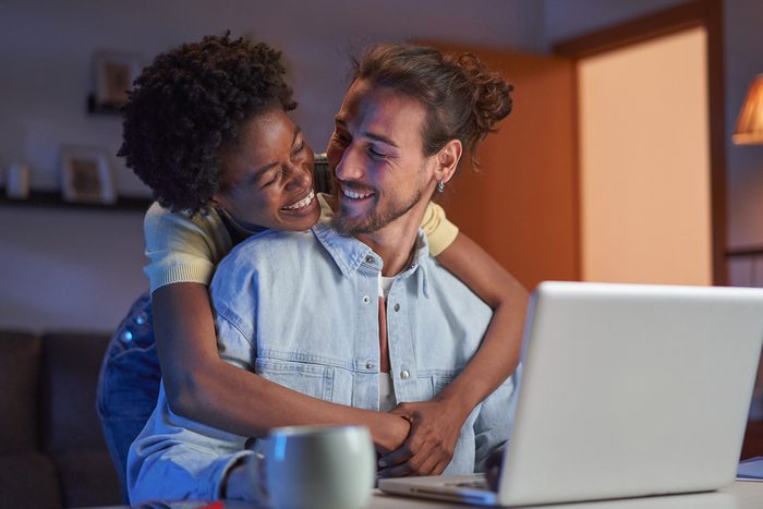 couple at home in front of laptop