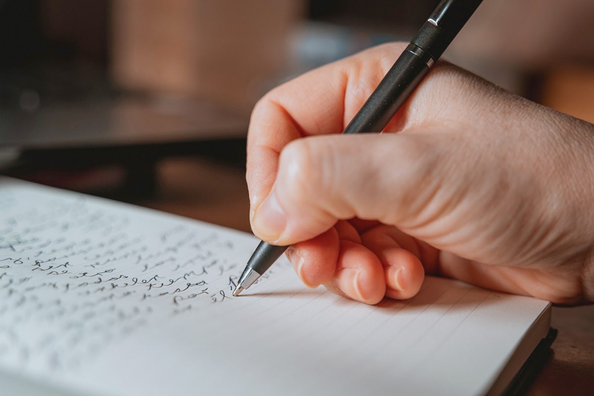 close up of woman's hand writing