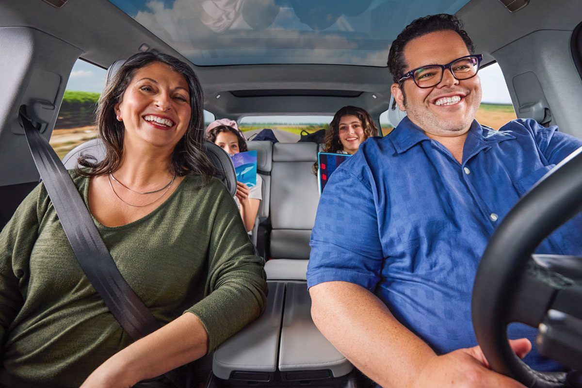 Actor Josh Gad smiling and driving the car