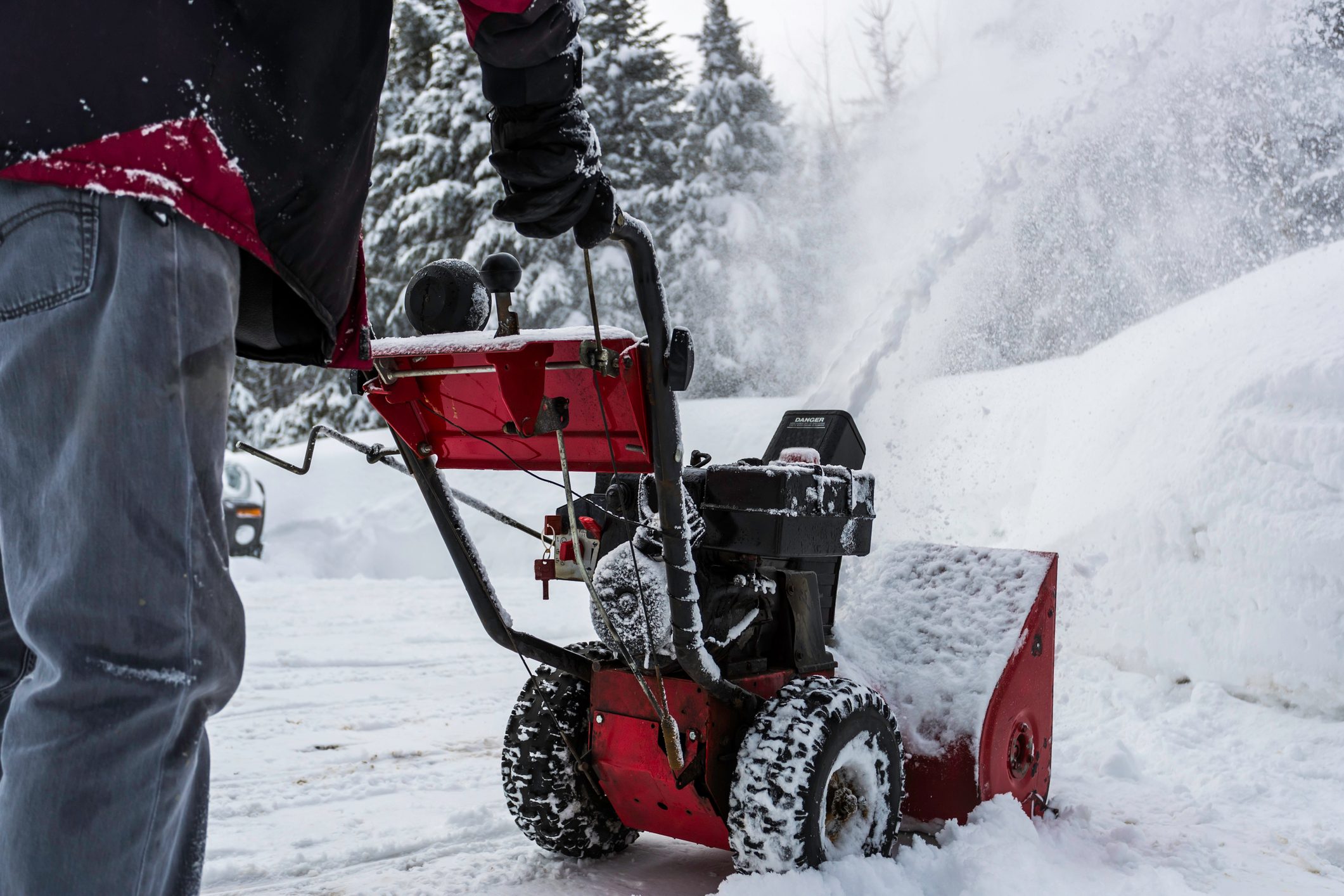 Senior Man Using SnowBlower After a Snowstorm