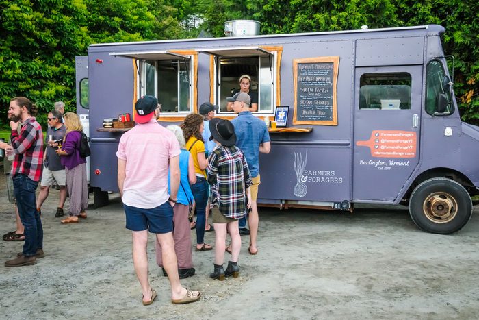 people lining up at a food truck
