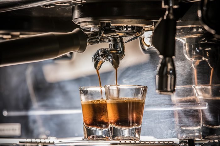 Espresso shot from the espresso machine with the mixed lighting of ambient and flash light