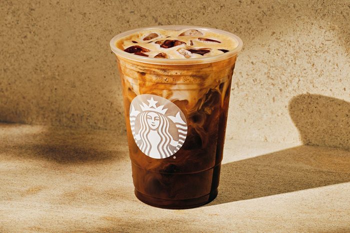 Starbucks Coffee in a transparent glass on the floor