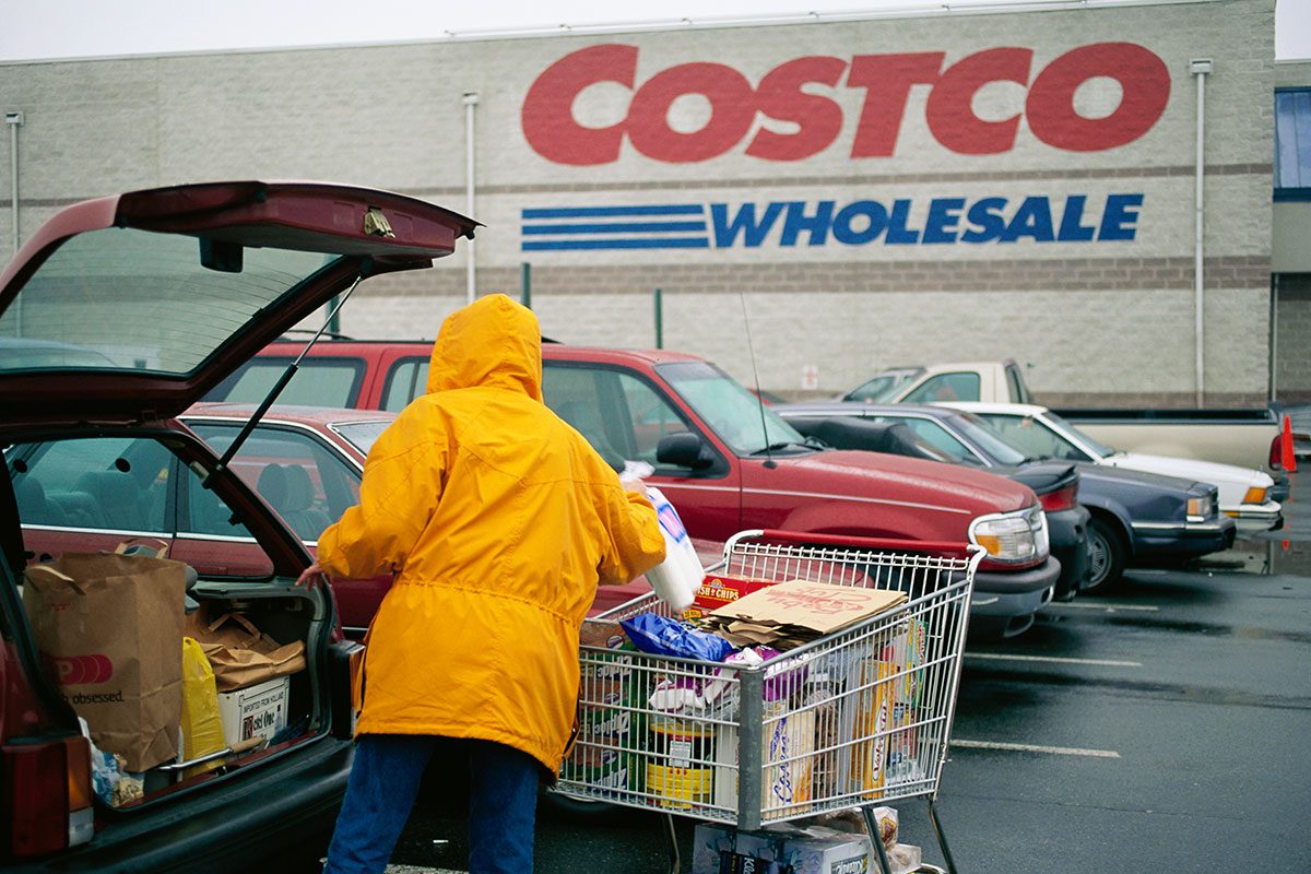 Customer Unloading Her Shopping Cart at Costco Parking Lot