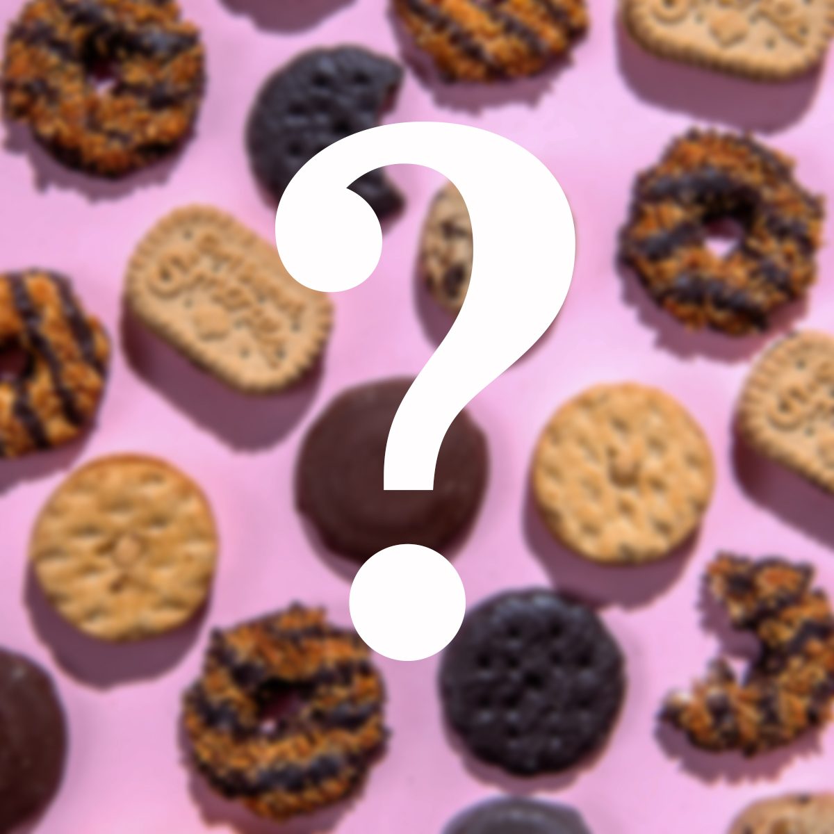 An assortment of cookies, including chocolate-covered and striped ones, arranged on a pink background with a large white question mark in the center.
