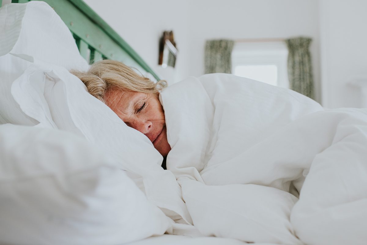woman in white duvet in double bed